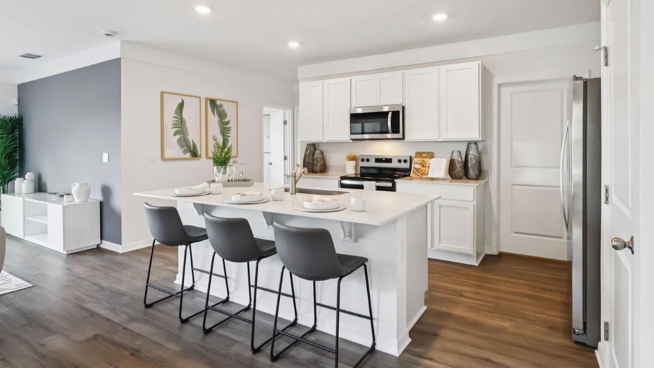 Kitchen view of island with seating and pantry