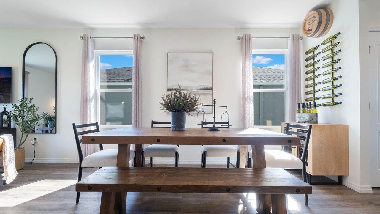 large dining room with table for 6 people and two windows