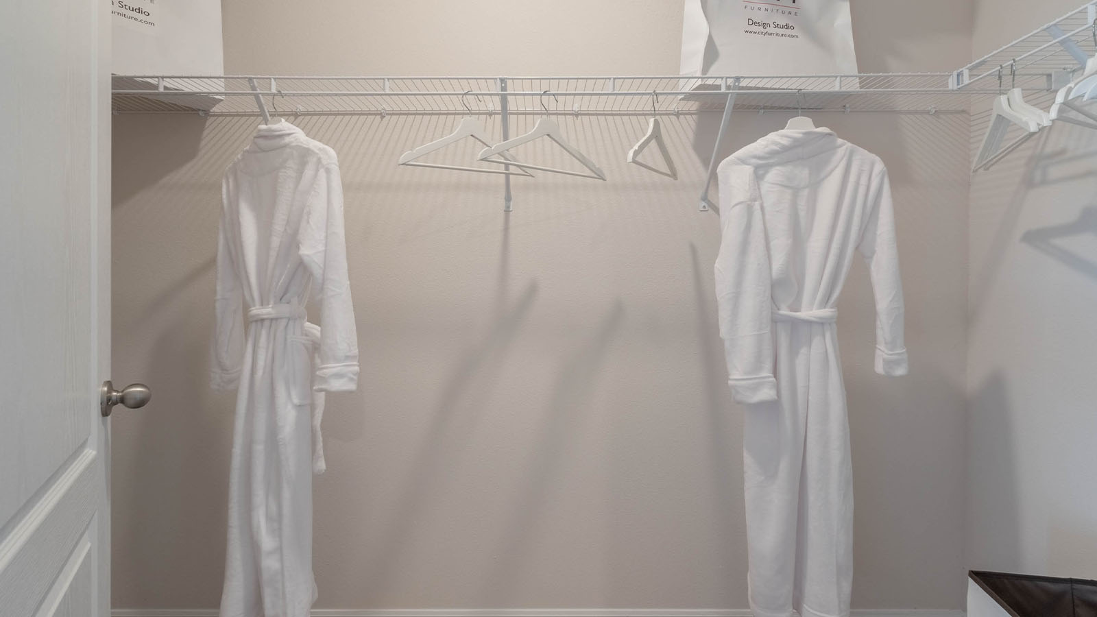 Primary bedroom walk in closet with decorations