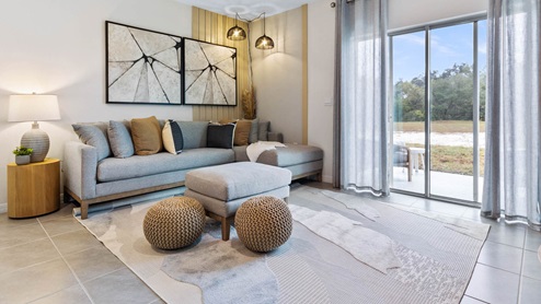 Living room with sectional couch and sliding glass doors