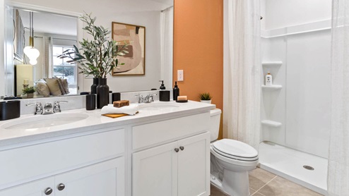 Primary bathroom with walk in shower and double sink vanity