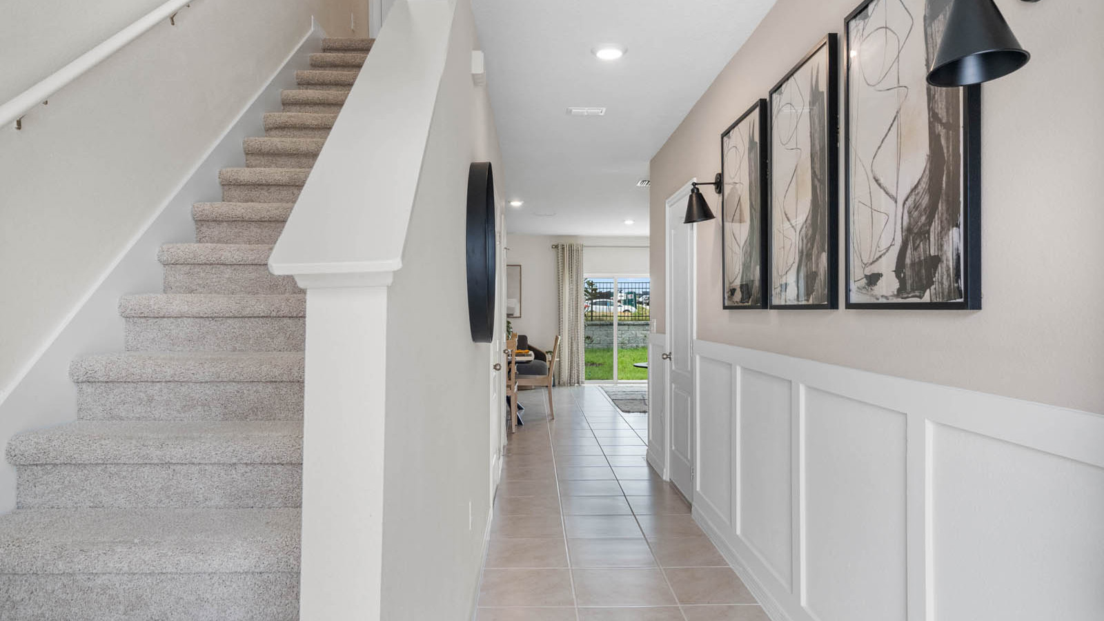 Entryway with view into main living space and stairs to second floor