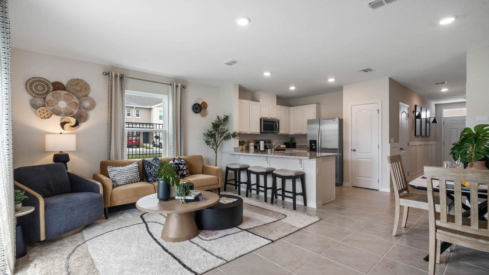 Living room with view of kitchen and entryway
