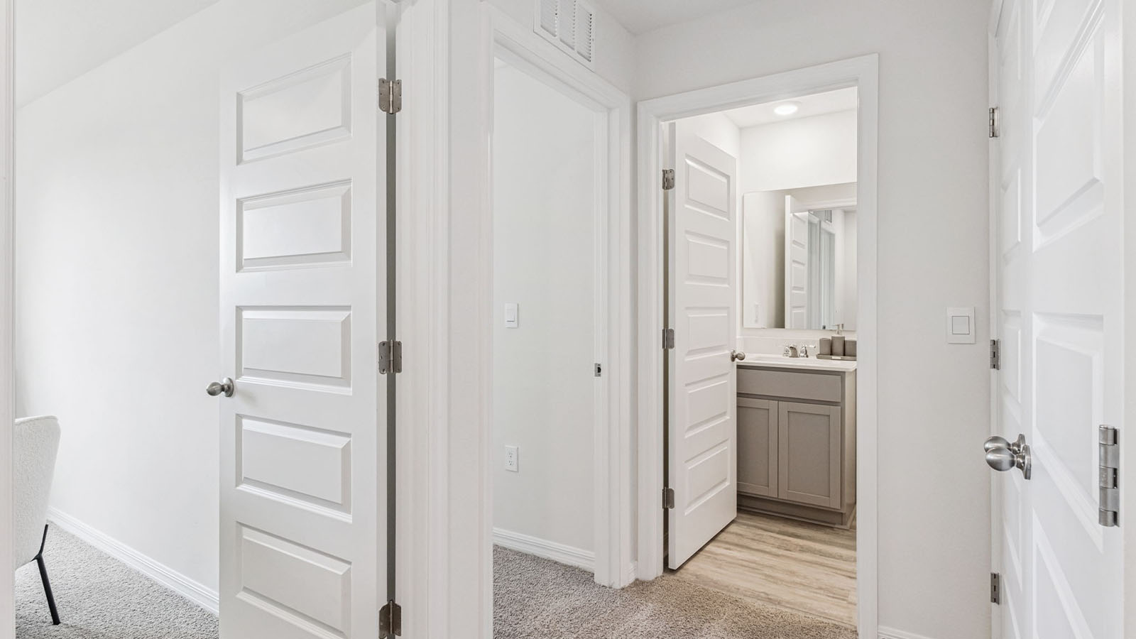 Upstairs hallway to guest bathroom and laundry closet