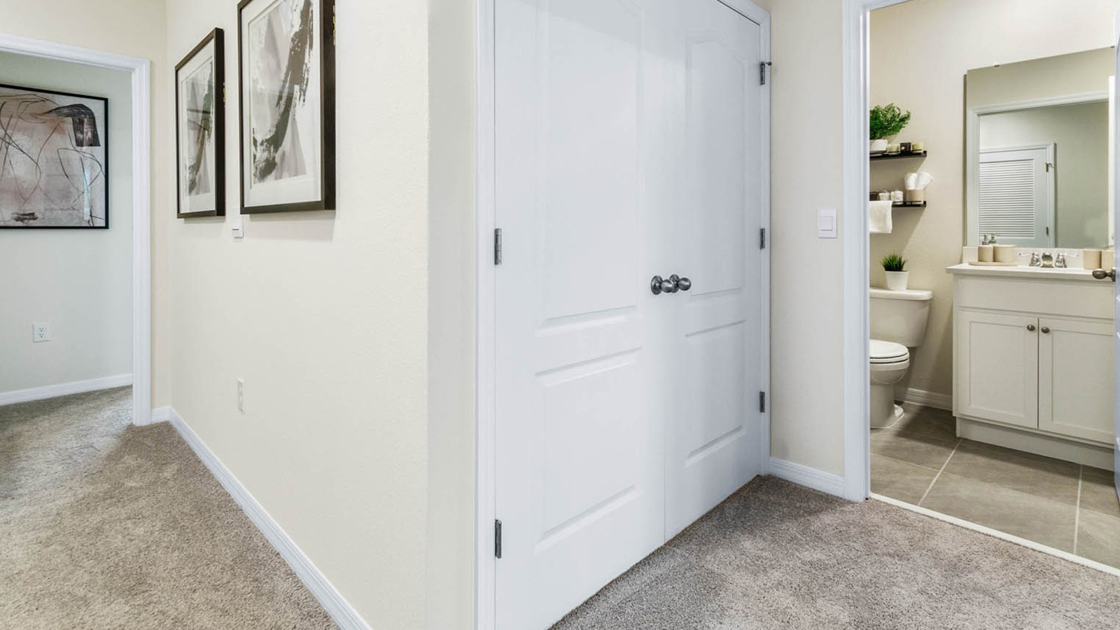 Upstairs hallway with laundry room and guest bathroom