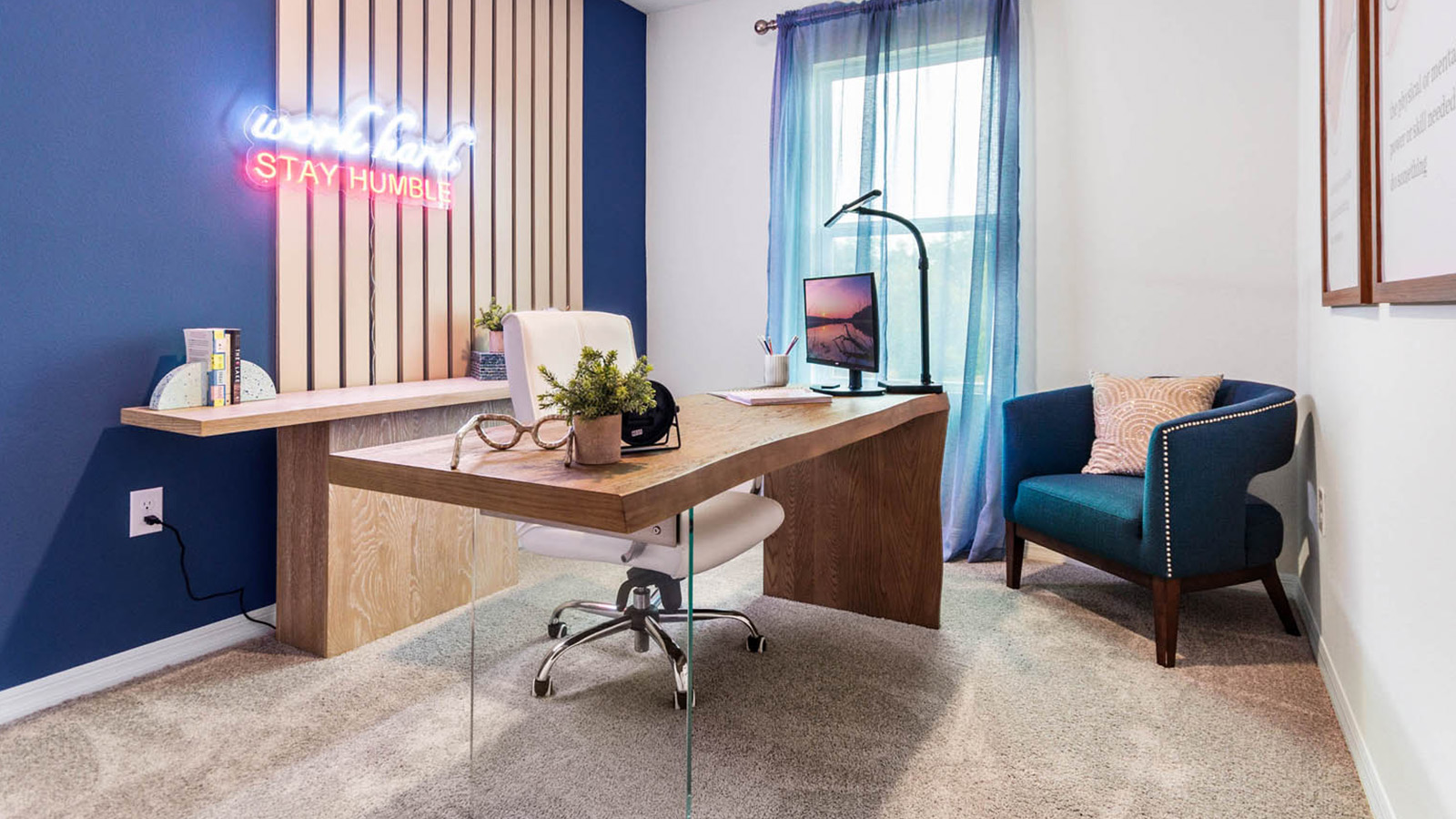 Guest room staged as an office with desk and seating