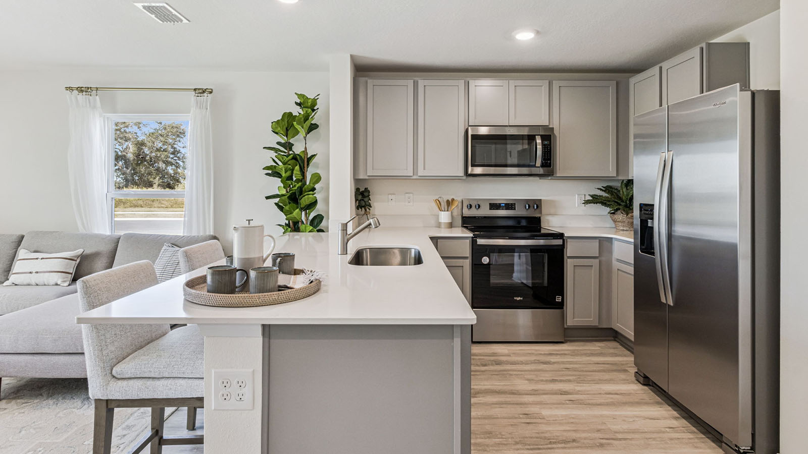 Open concept kitchen with peninsula overlooking living room