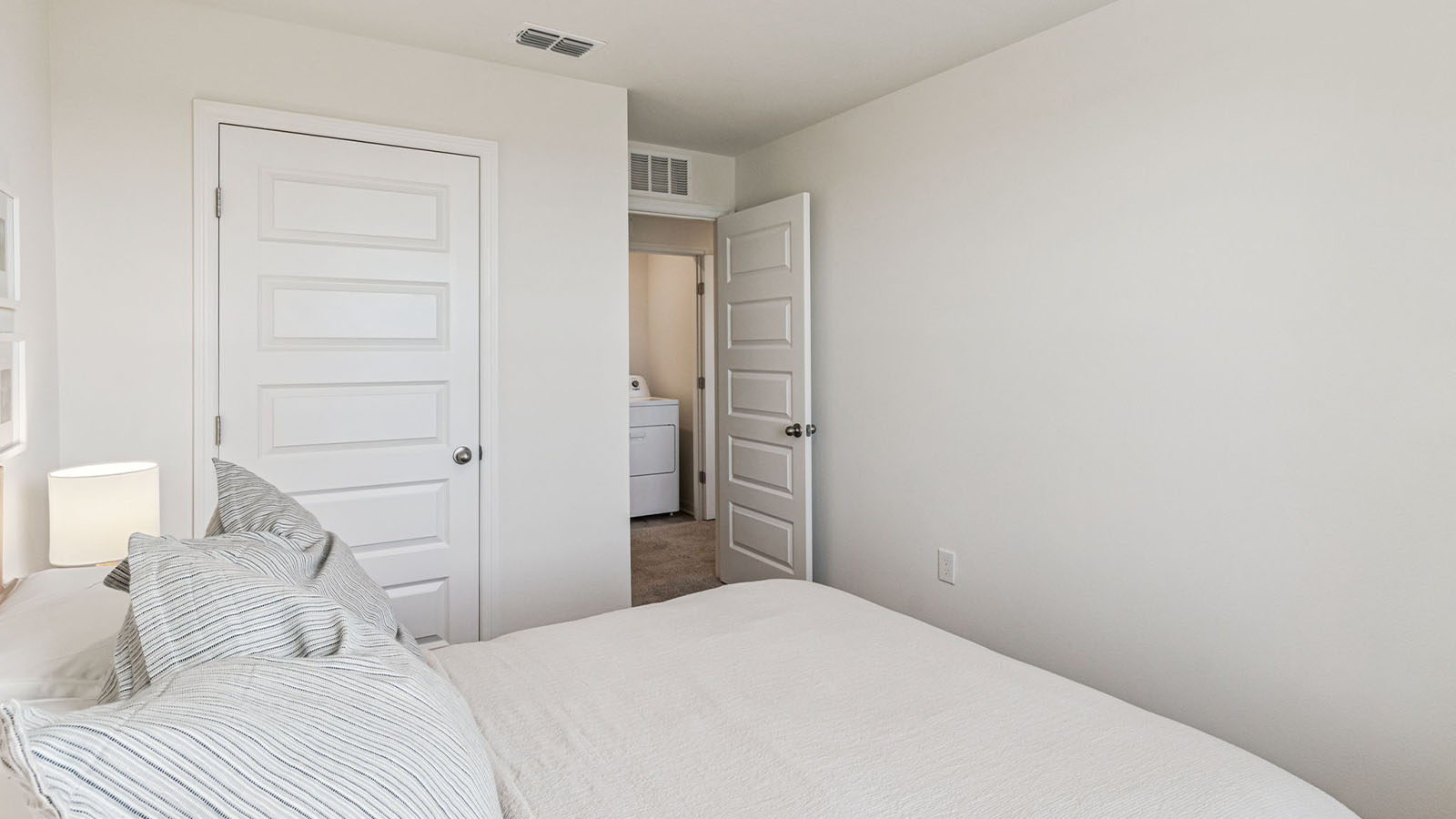 Primary bedroom with entrance to bathroom