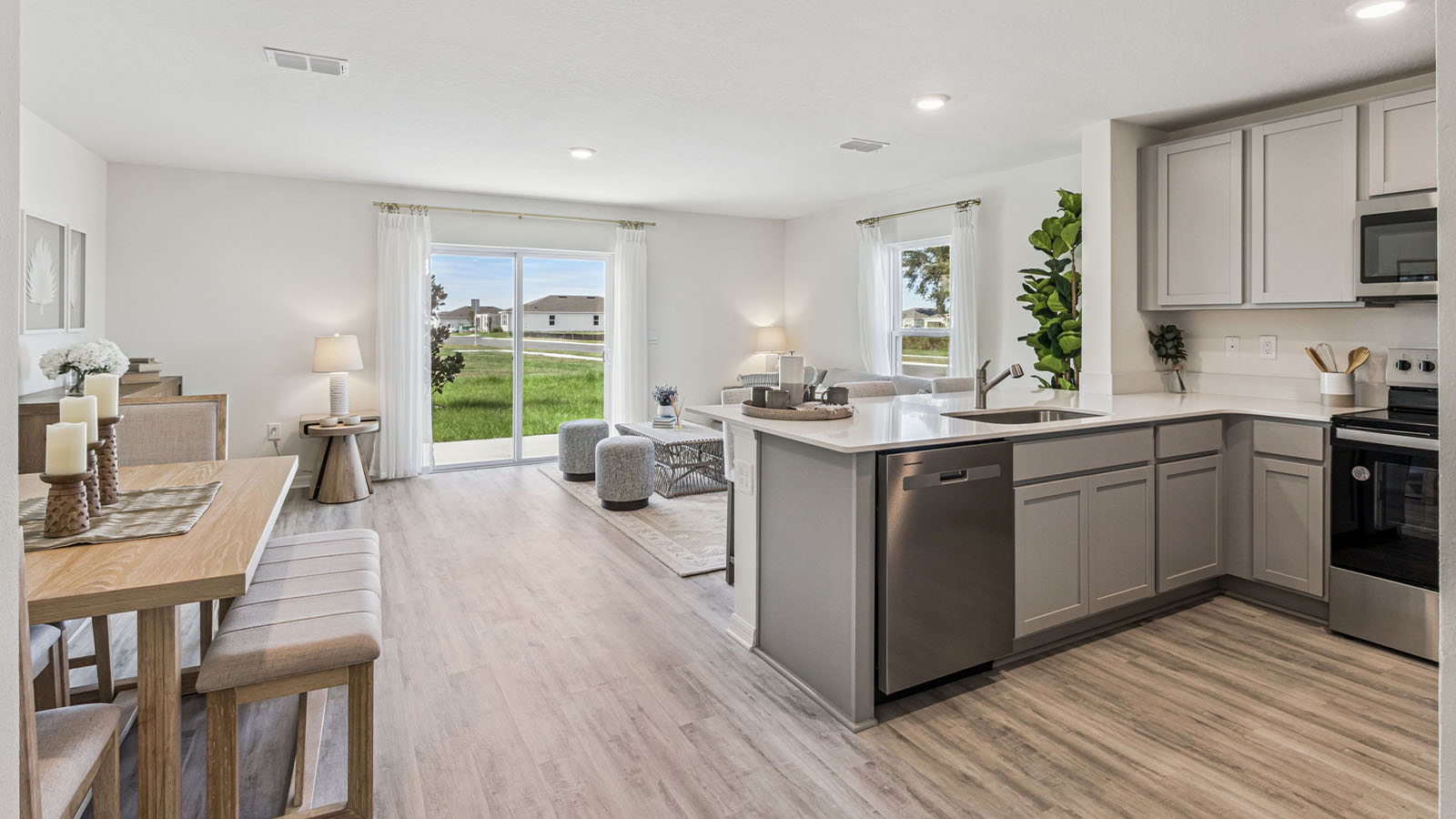 Kitchen with island and barstools with view to entryway