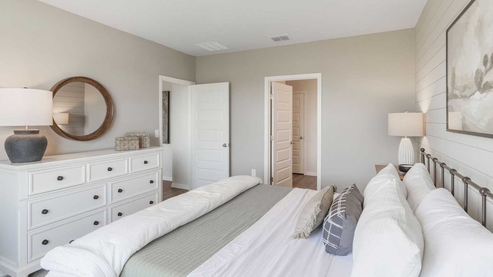 Primary bedroom with a queen bed and vanity