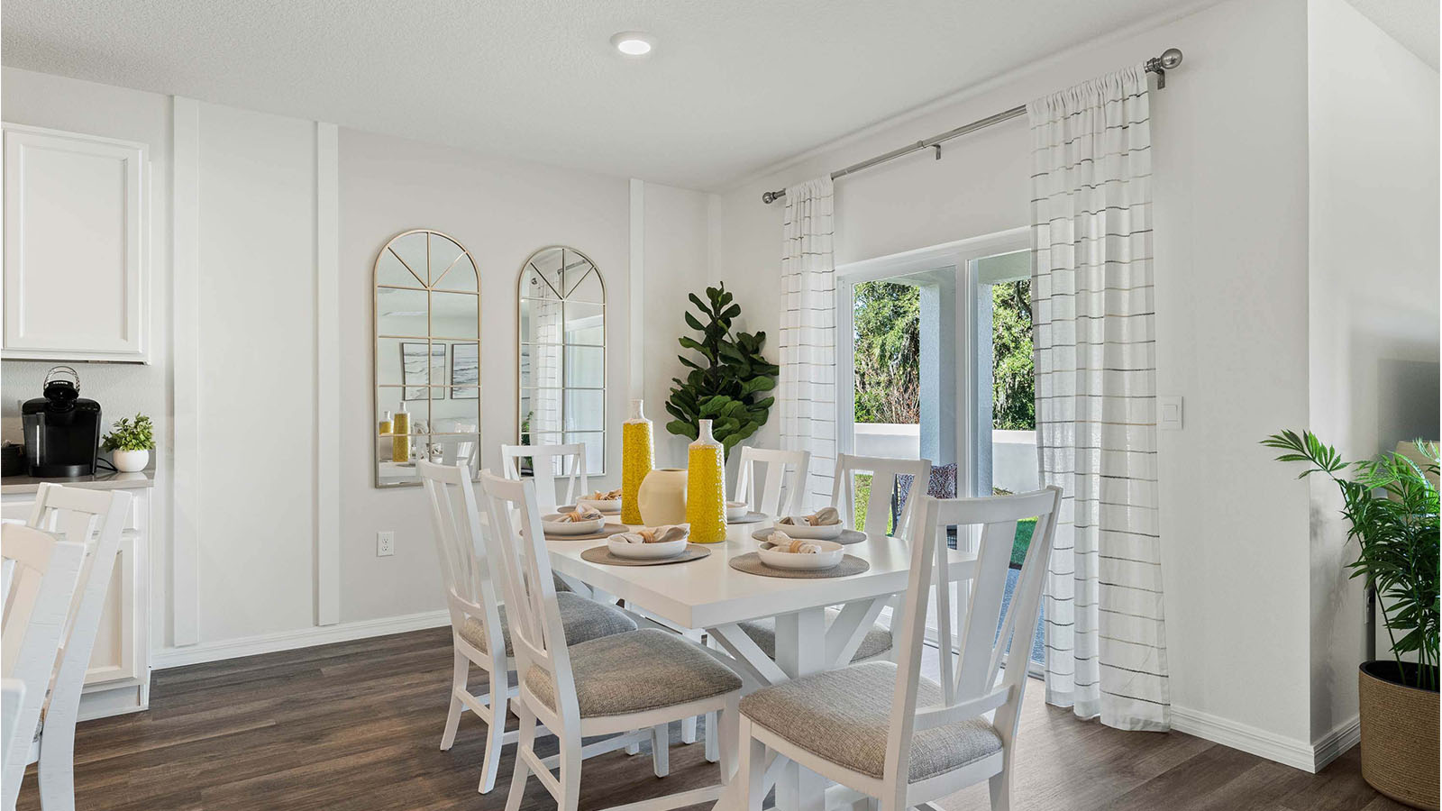 Dining room with table and doors to covered patio