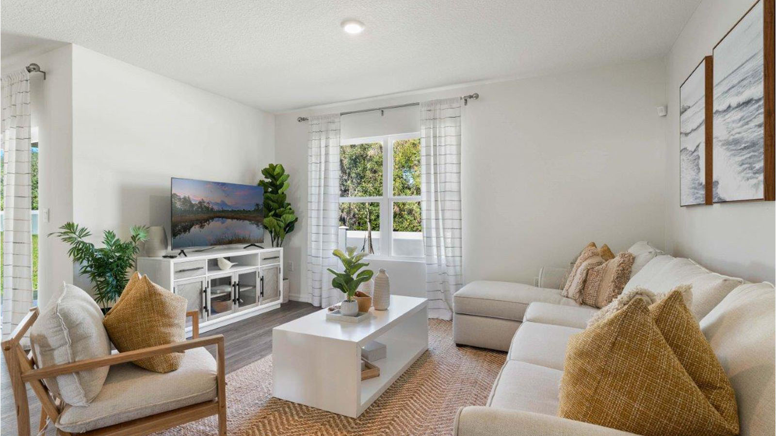 Living room open to the dining roon and kitchen with windows