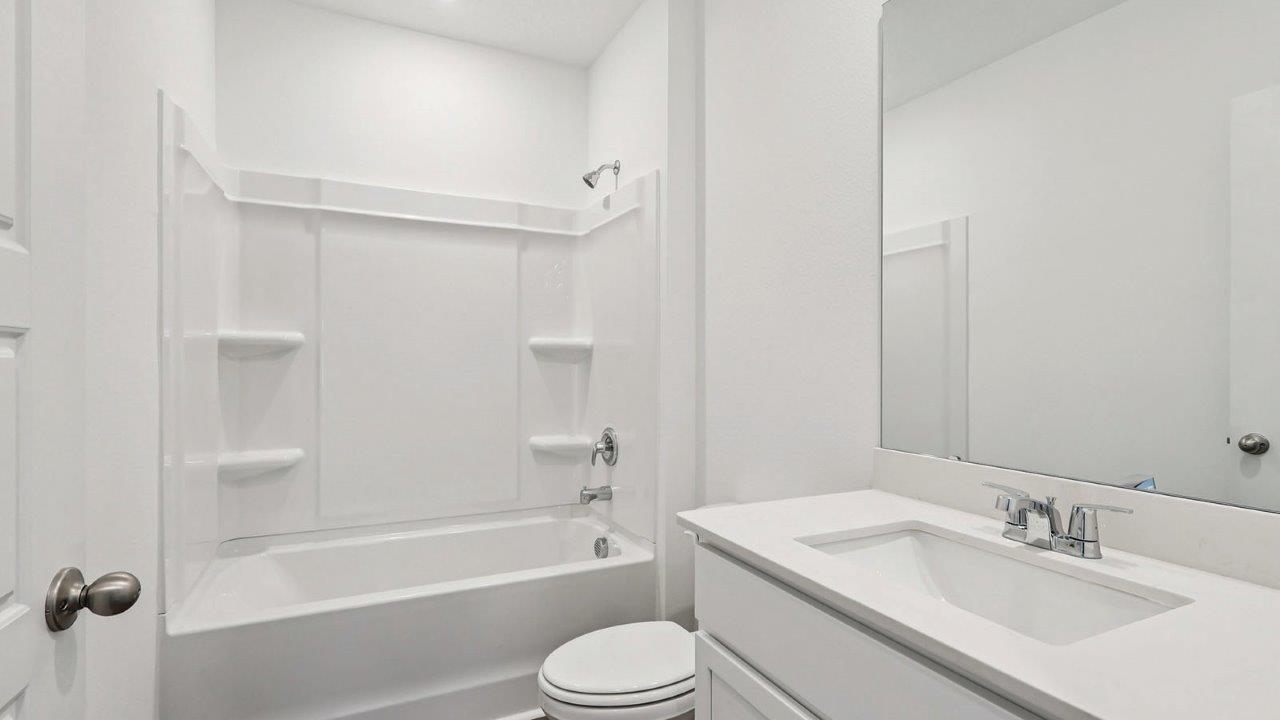 guest bathroom with tub and single sink