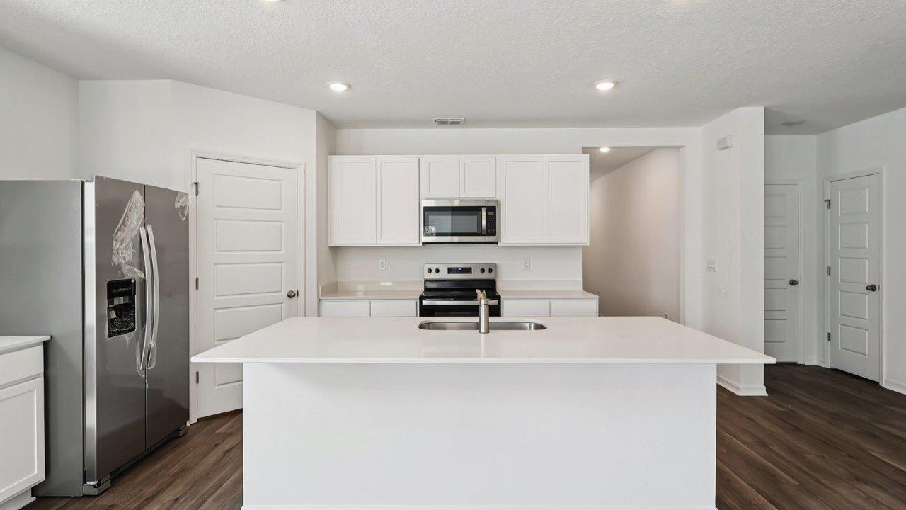 Kitchen with island and white cabinets