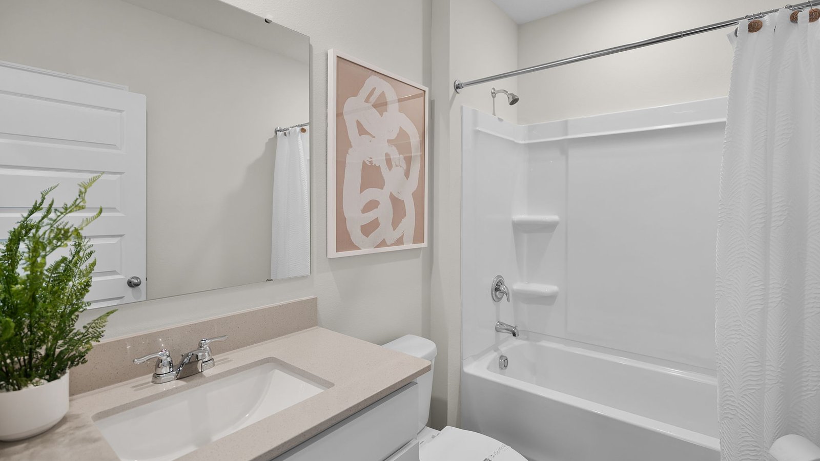 Guest bathroom with quartz countertops and tub