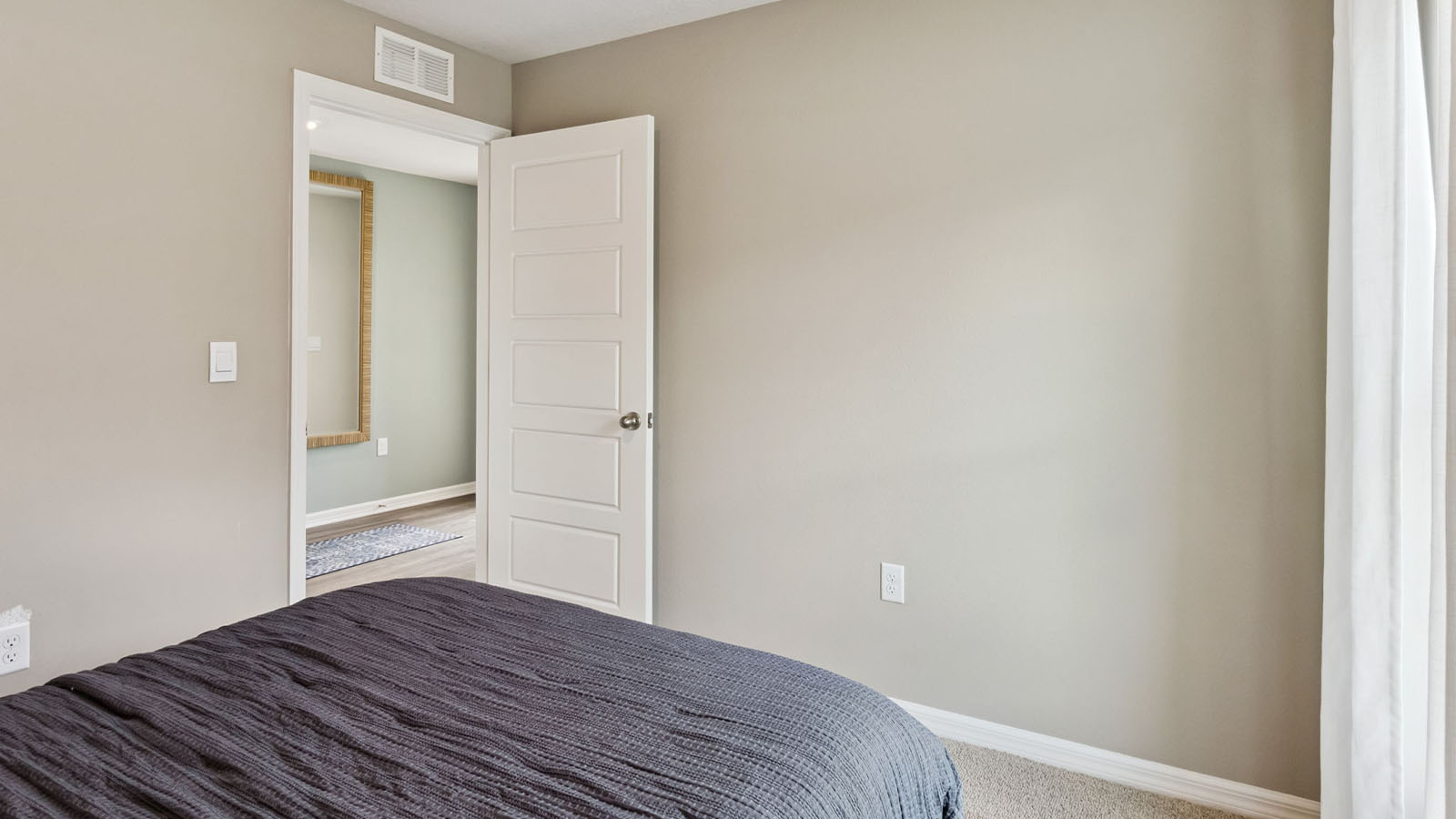 Guest bedroom with carpet flooring