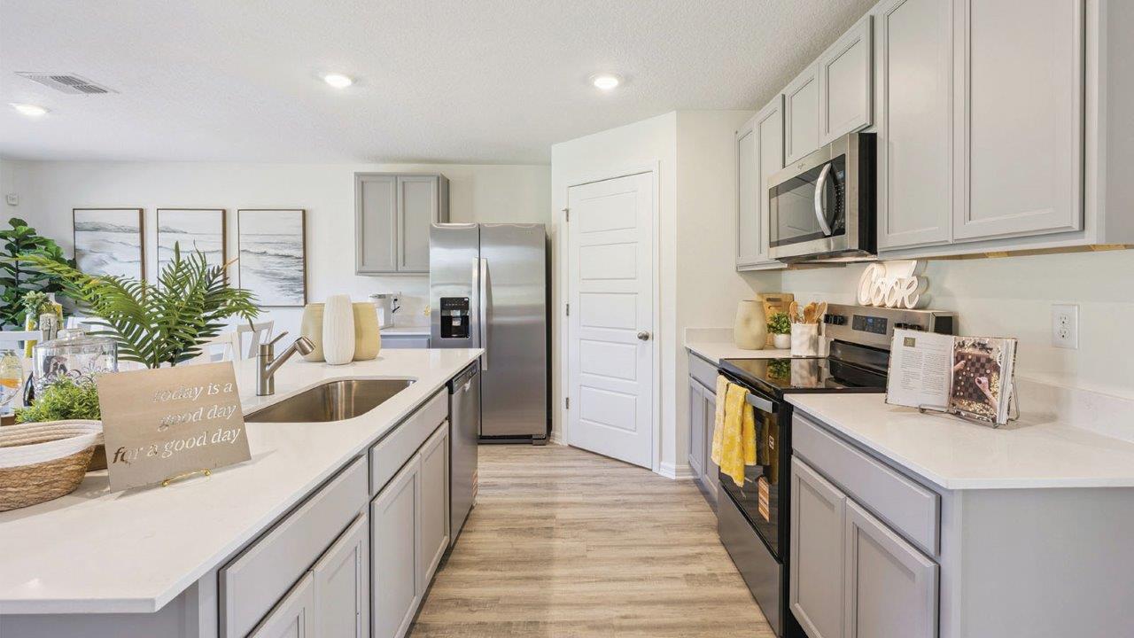 Kitchen with stainless steel appliances and pantry