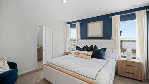 Primary bedroom with carpet throughout the room