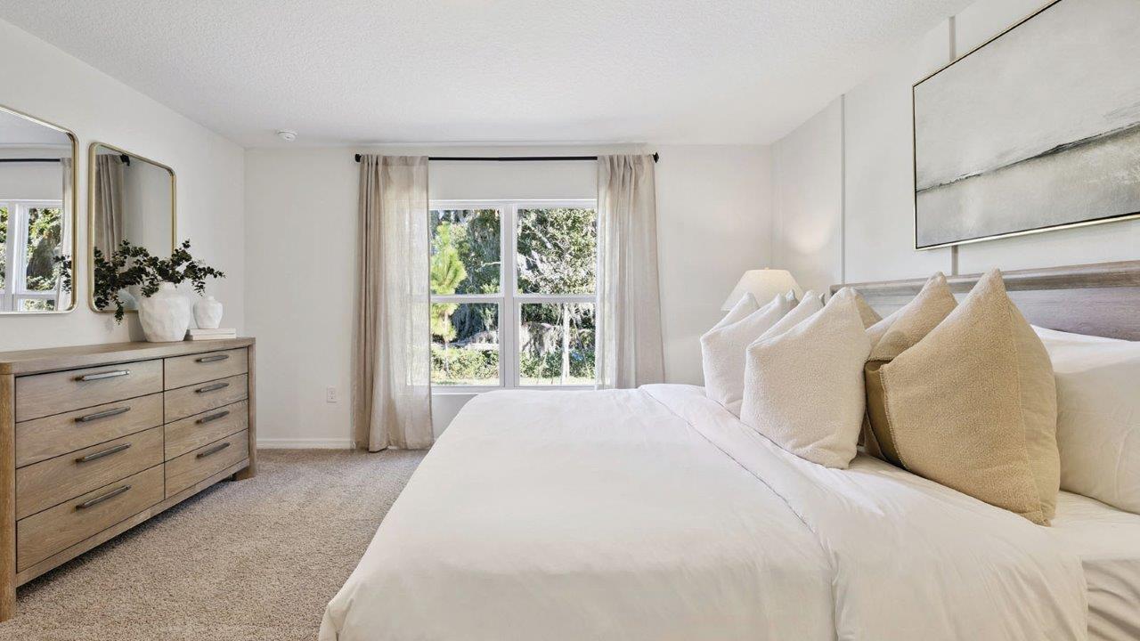 Primary bedroom showing bed and dresser