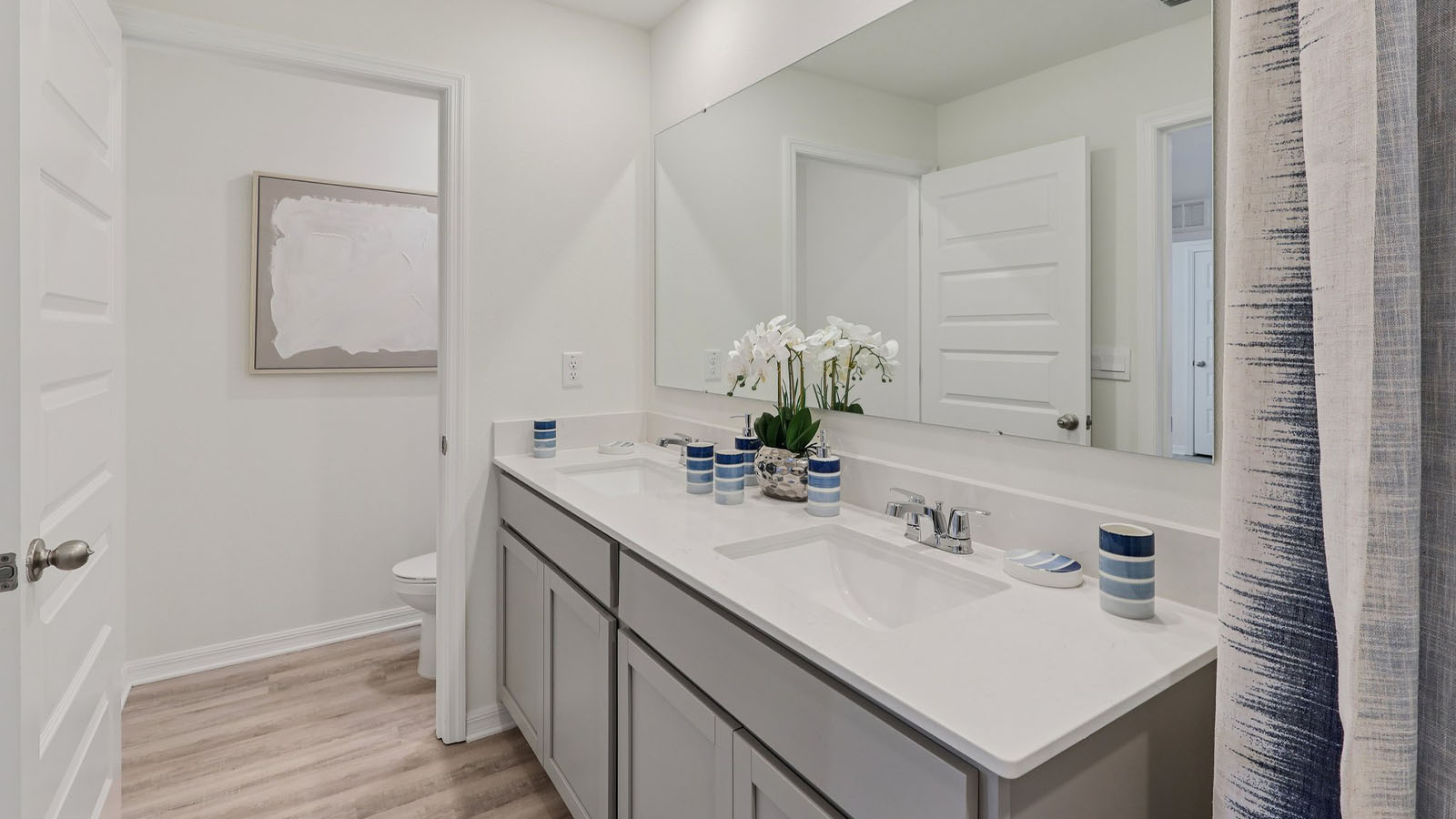 Primary bathroom with dual vanity sinks and walk-in shower