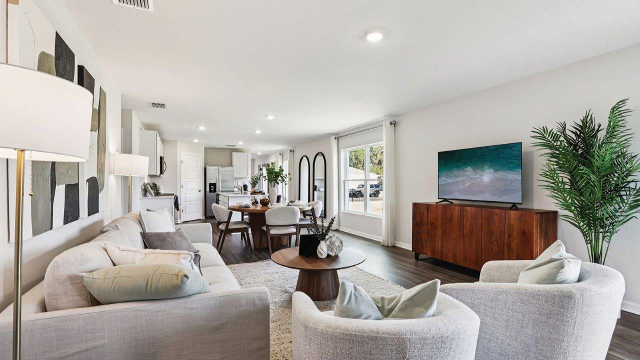 Living room decorated with sofa, chairs, and art