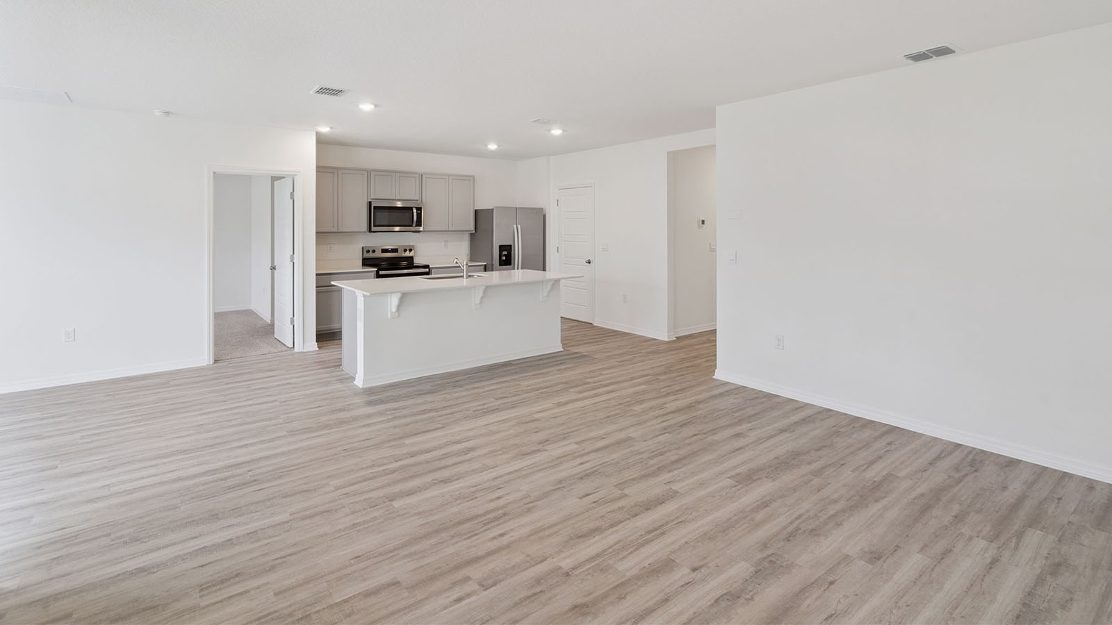 Living Room with luxury vinyl plank looking to kitchen and dining room