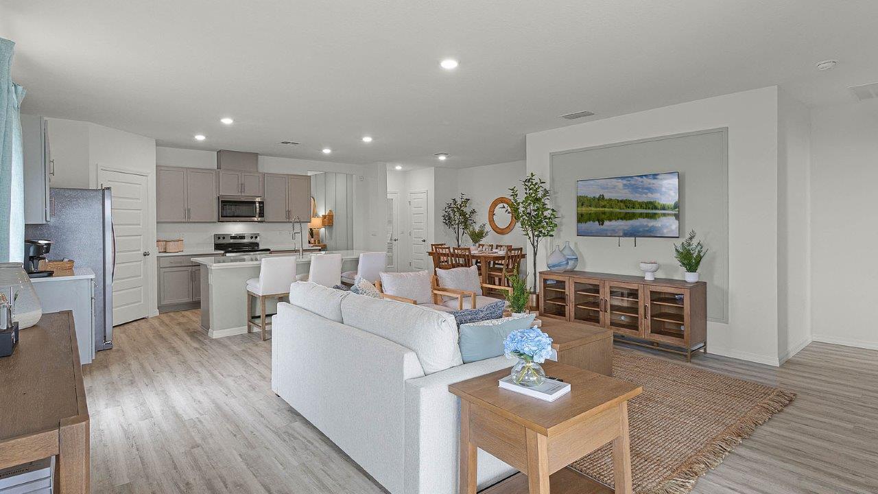 Open concept living spaces with views of the kitchen and dining room