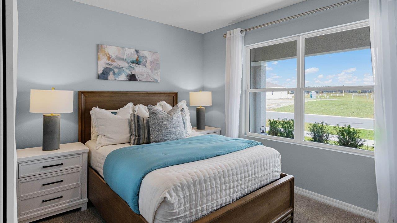 Guest bedroom with large windows and carpet