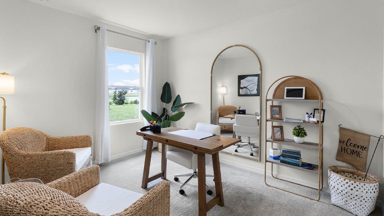 Guest room displayed as additional home office with window and carpet flooring