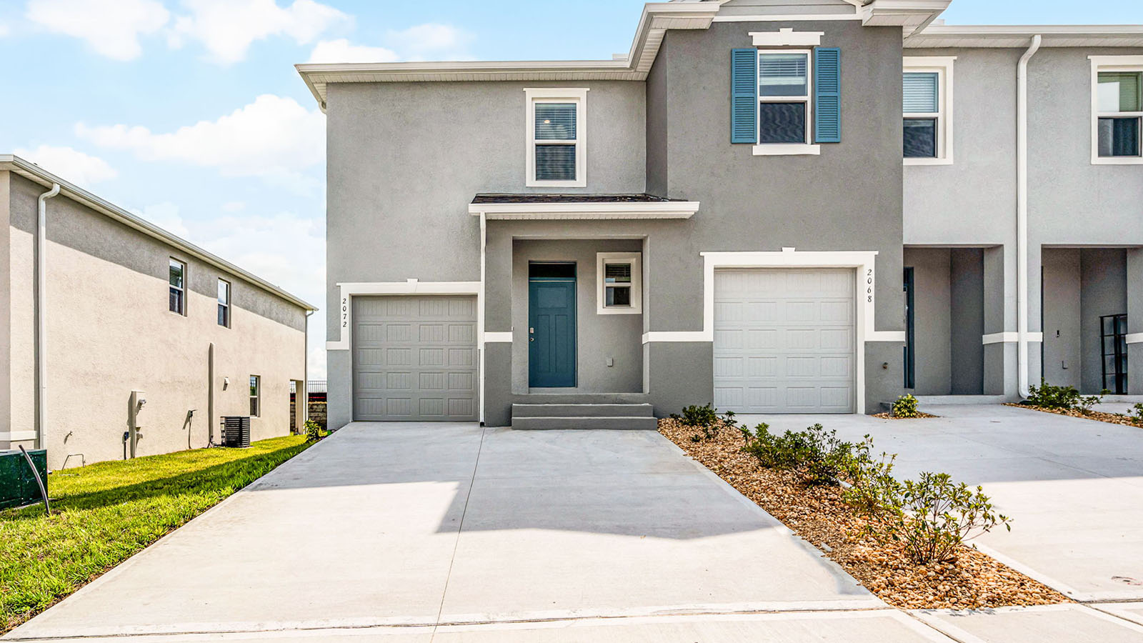 Exterior image of two story townhome and single car garage