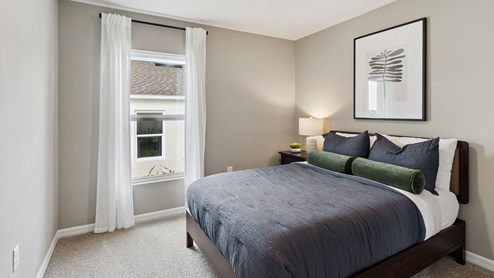 Guest bedroom with carpet flooring