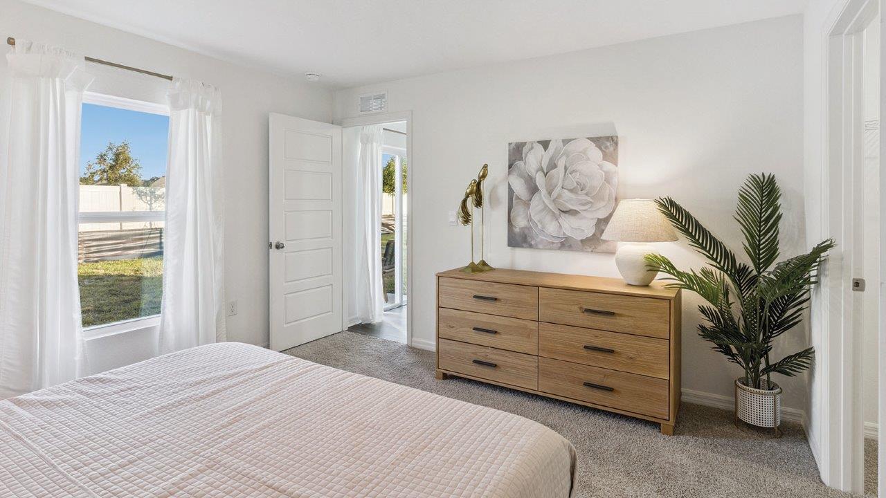 Primary bedroom with carpet flooring