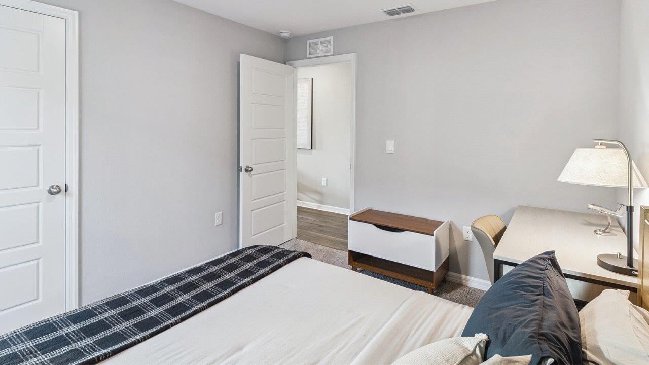 Guest bedroom with carpet flooring