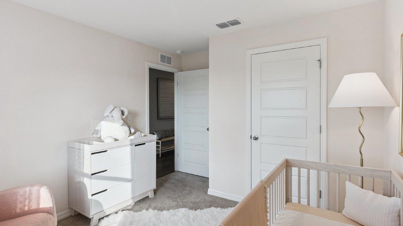 Nursery room with carpet throughout