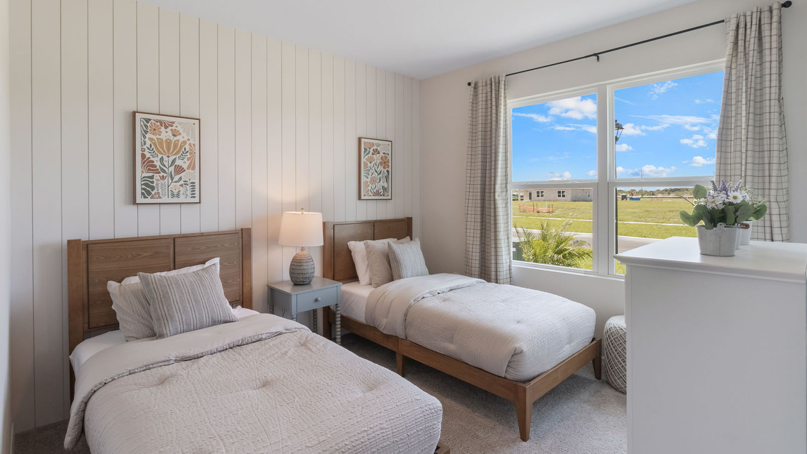 guest bedroom with two twin bedrooms and carpet throughout