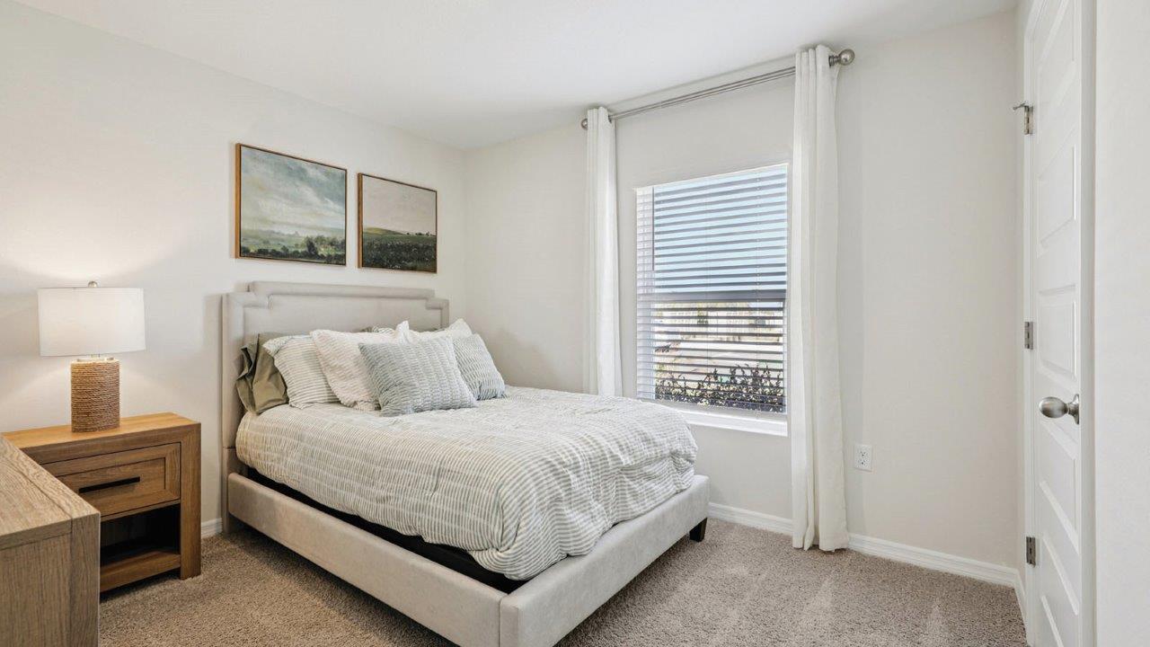 Guest bedroom with window and full size bed