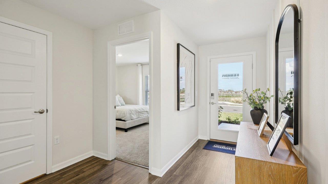 Entryway showing front door and guest bedroom