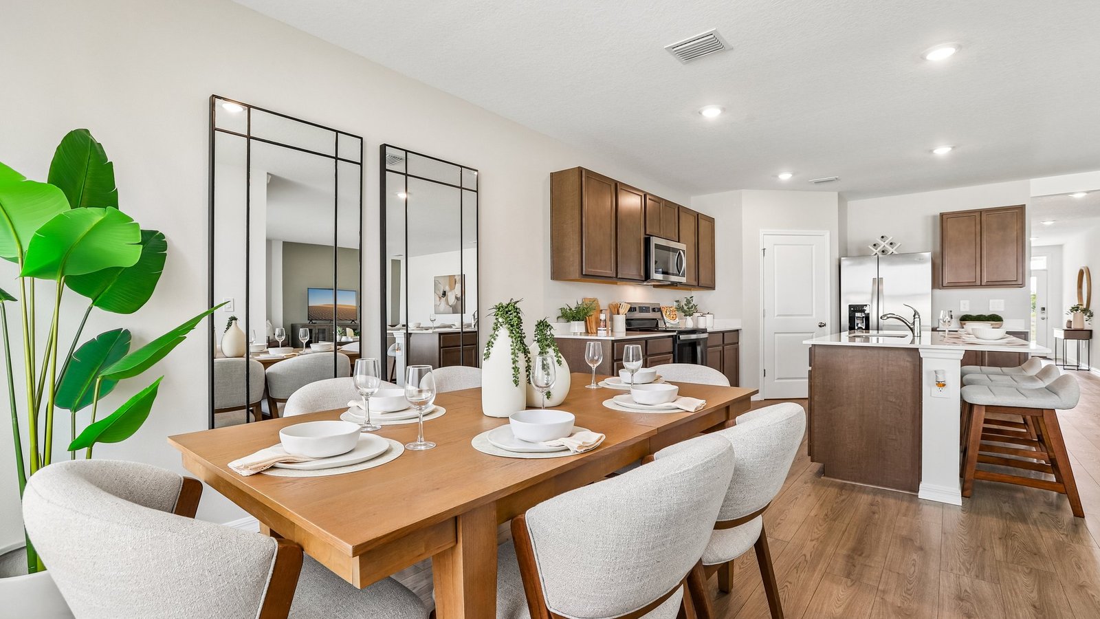 Dining room adjacent to the kitchen with table, chairs and LVP flooring.