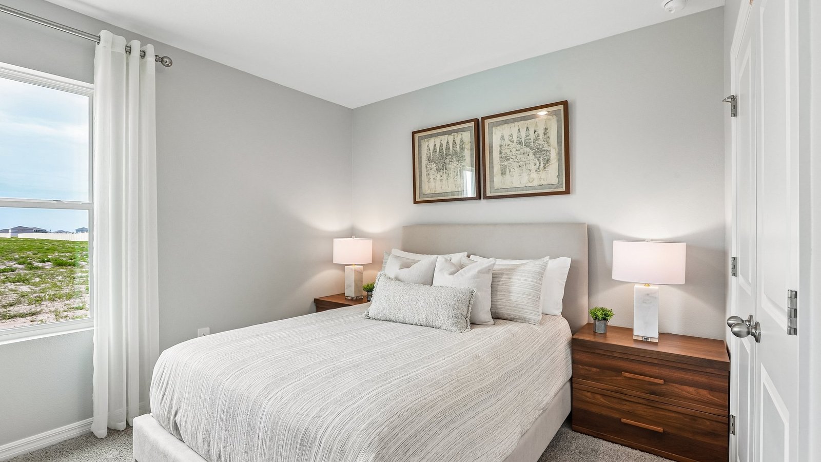 Guest bedroom with bed, nightstands and a roomy closet for storage.