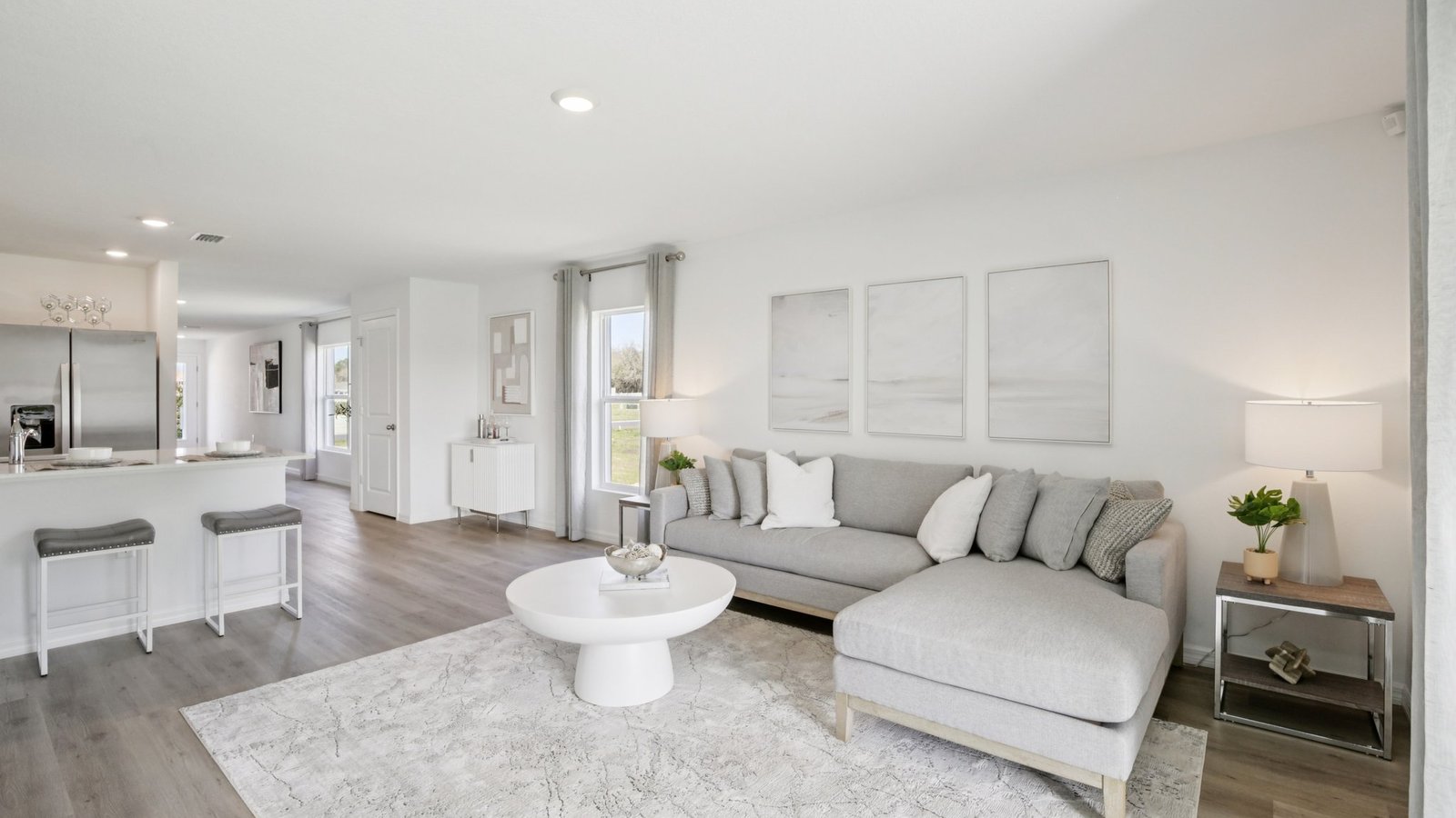 Open concept living area with couch seating and access to the backyard thru slider door.