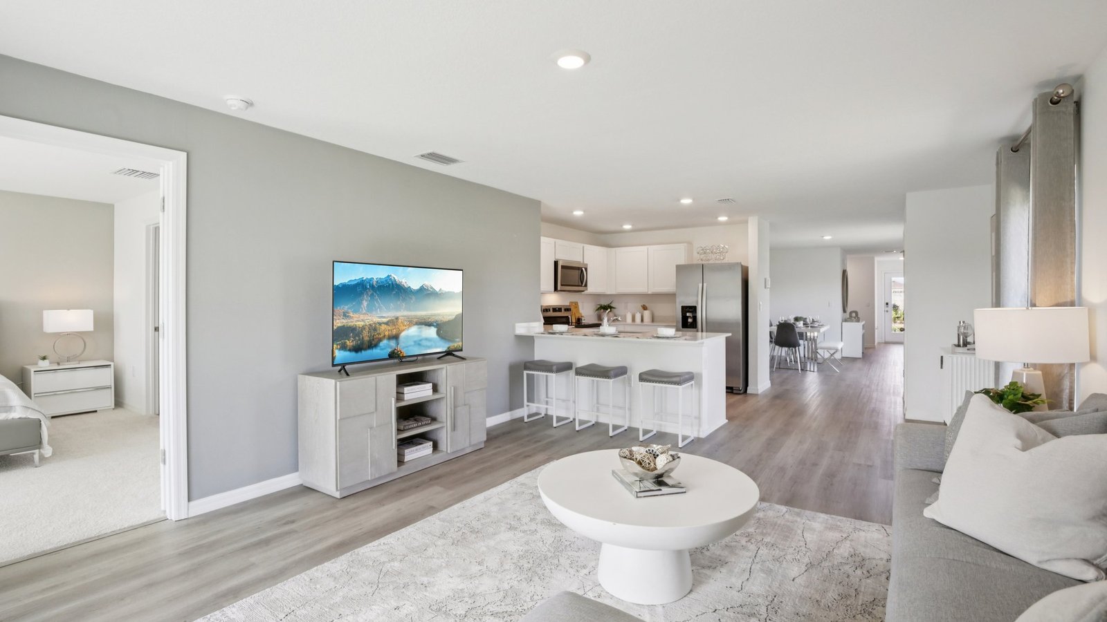 Open concept living area with couch seating and access to the backyard thru slider door.