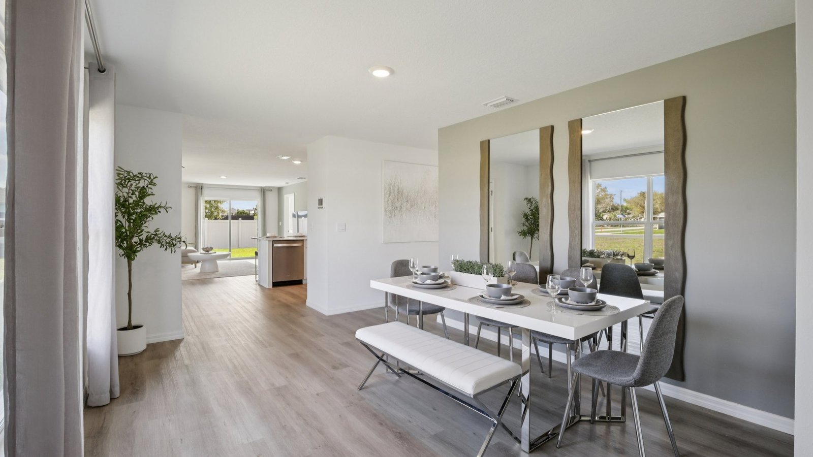 Dining room adjacent to the kitchen with table, chairs and LVP flooring.