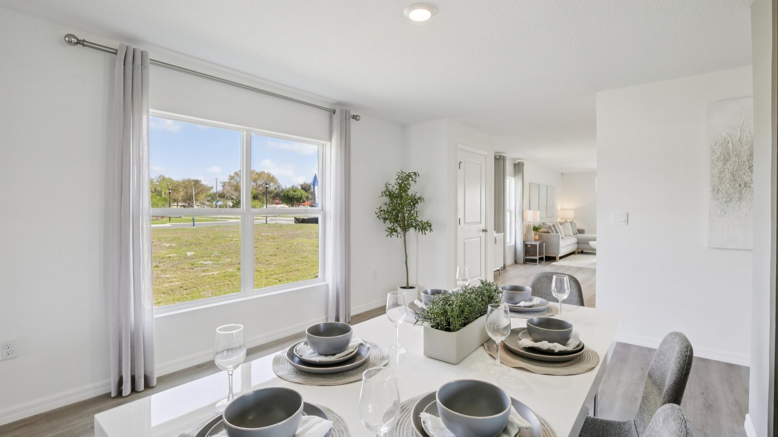 Dining room adjacent to the kitchen with table, chairs and LVP flooring.