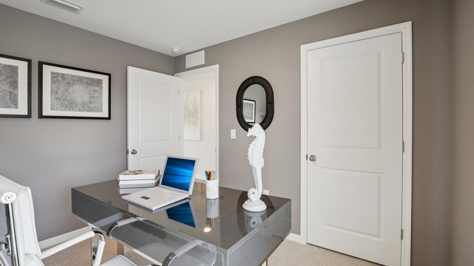 Multi-purpose office space with desk, seating and windows for natural lighting.