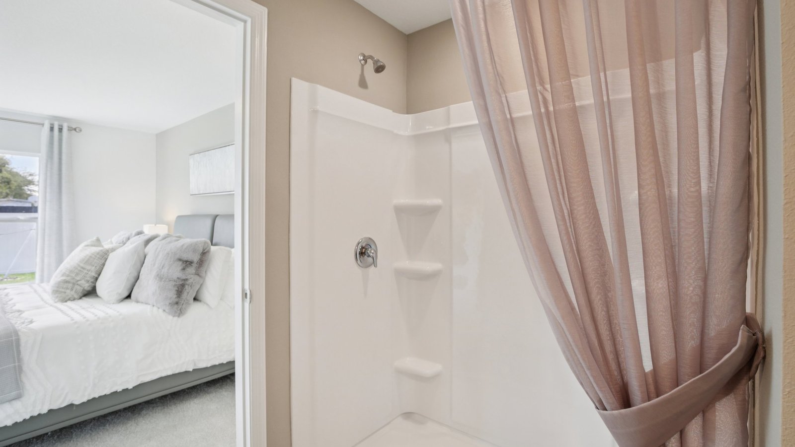 Modern bathroom with double vanity sinks, large wall mirror, cabinets and quartz countertops.