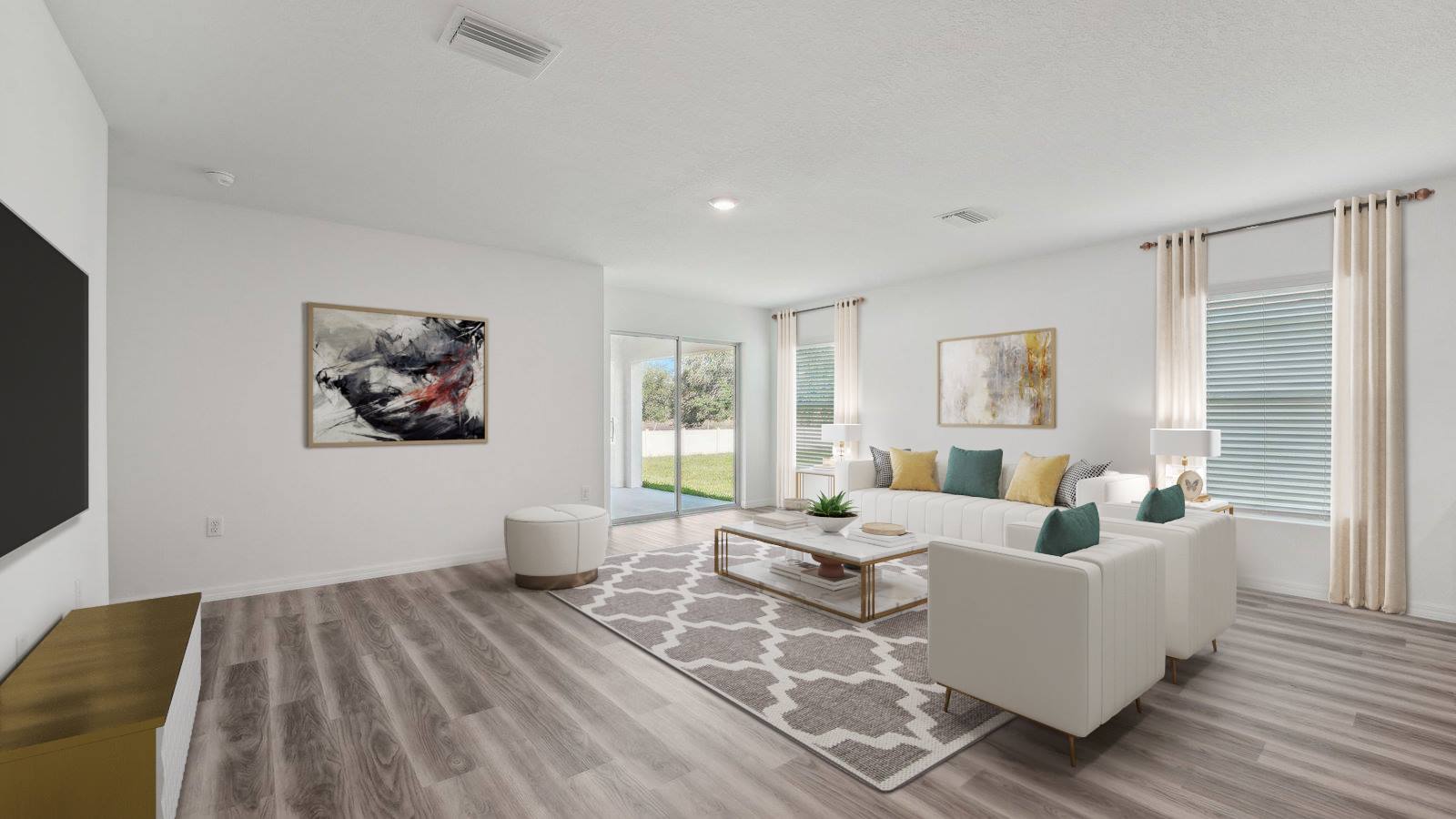 Open concept living area with couch seating and access to the backyard thru slider door.
