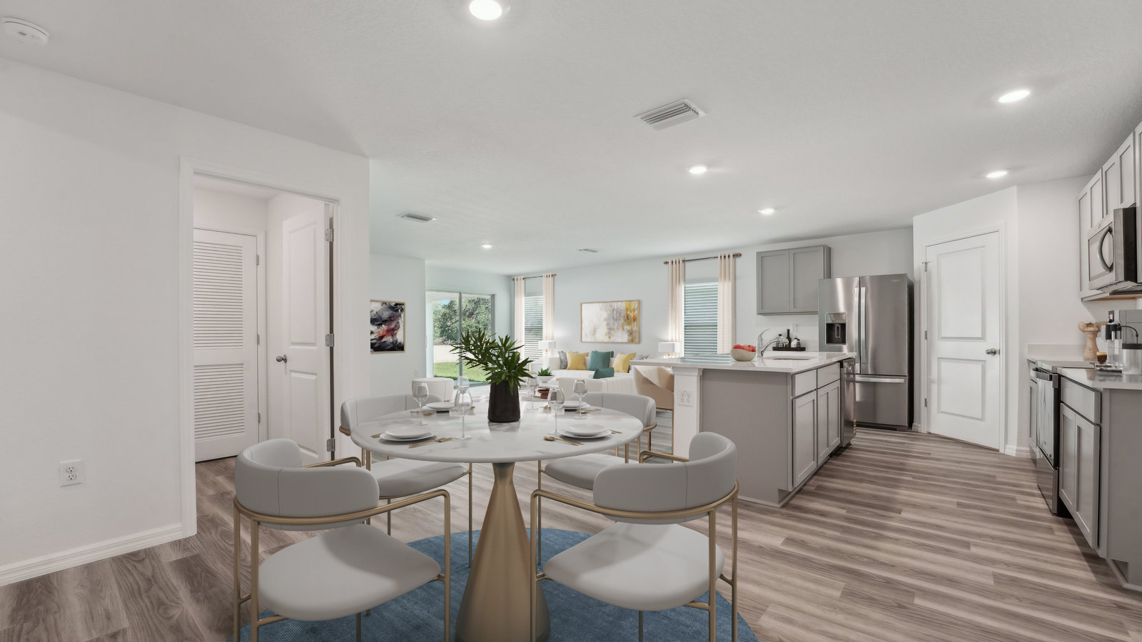 Dining room adjacent to the kitchen with table, chairs and LVP flooring.