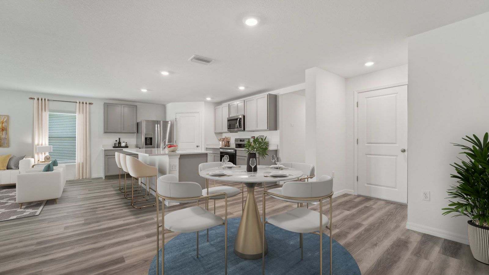 Dining room adjacent to the kitchen with table, chairs and LVP flooring.