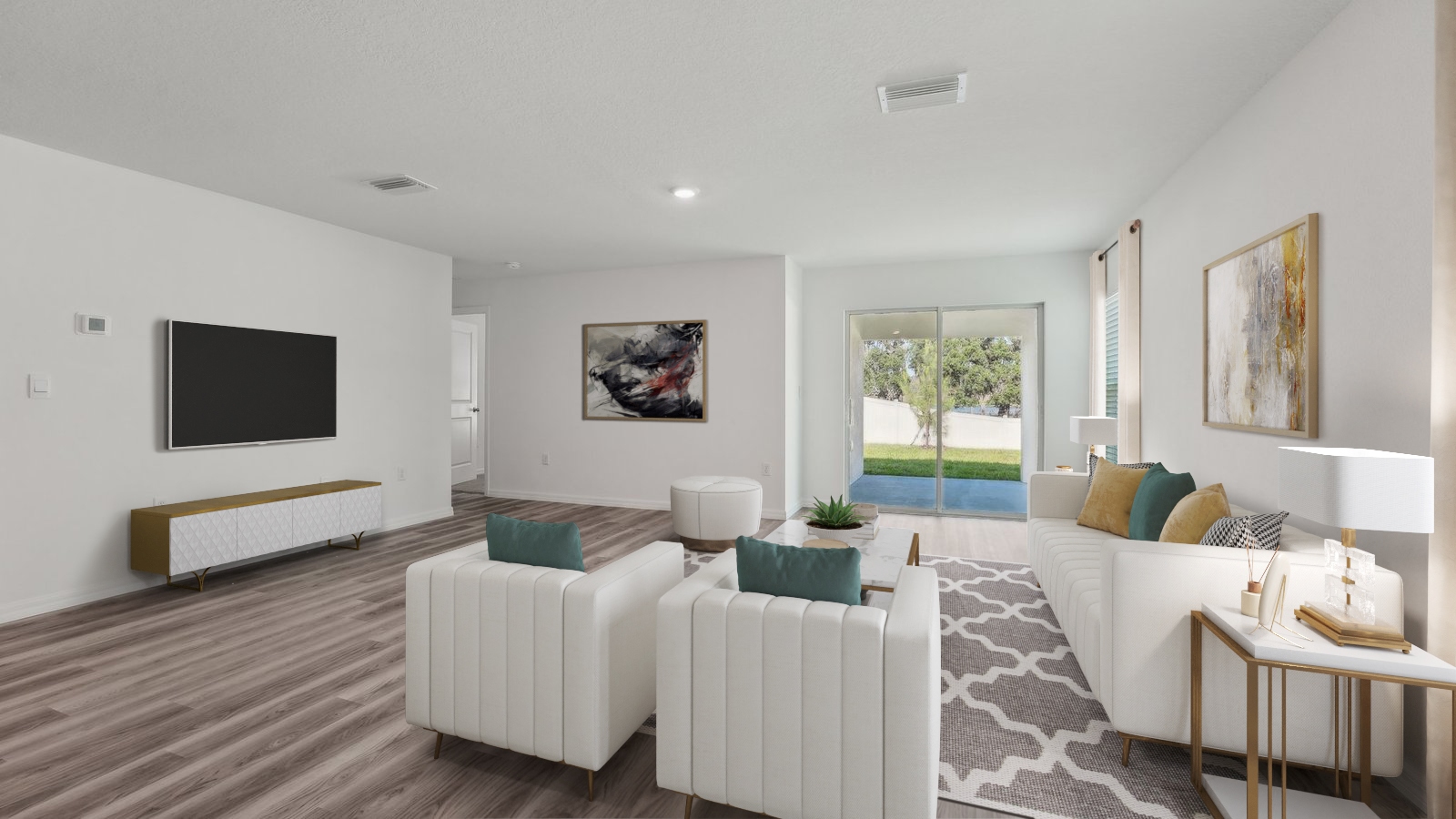 Open concept living area with couch seating and access to the backyard thru slider door.