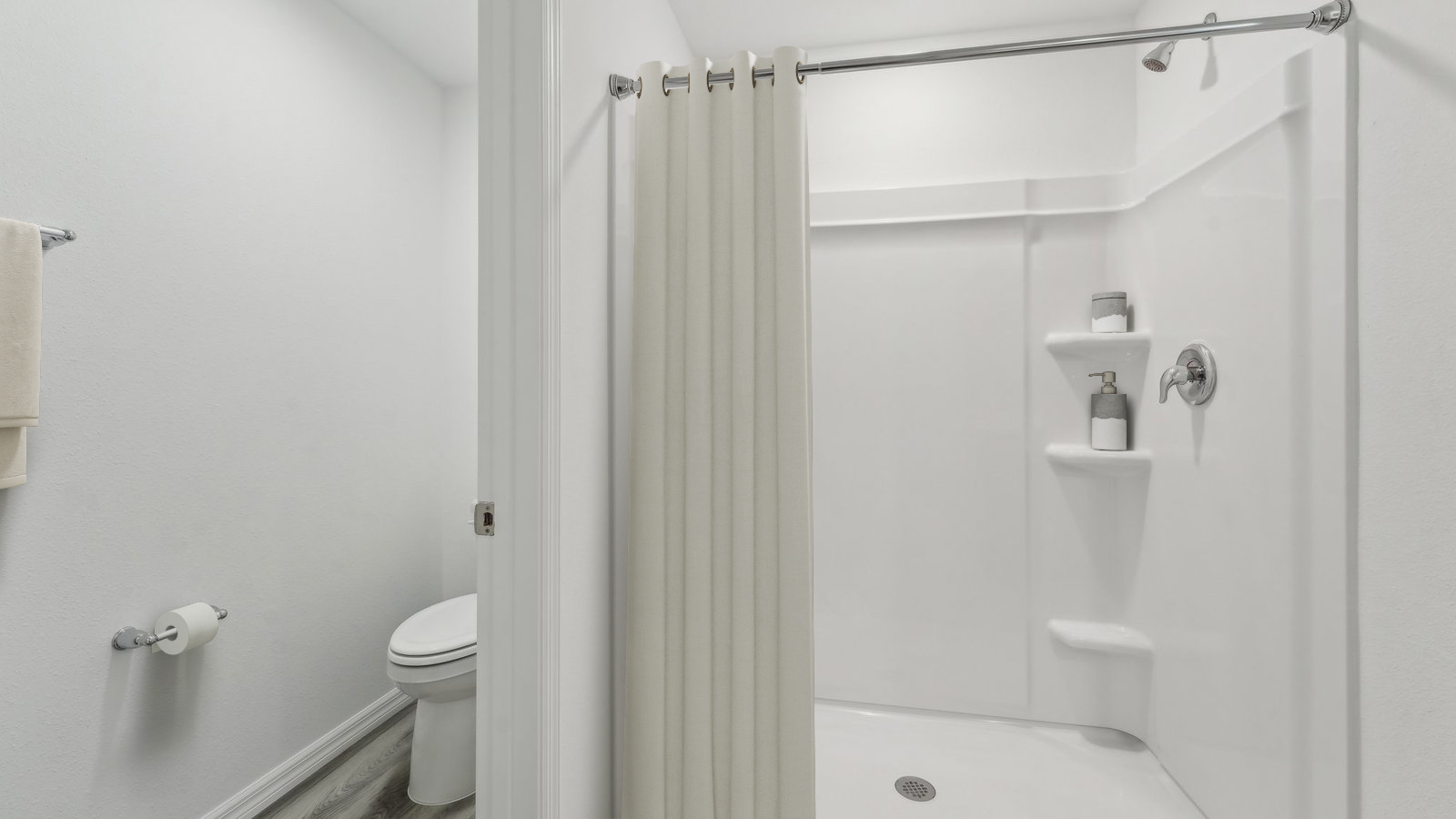 Modern bathroom with double vanity sinks, large wall mirror, cabinets and quartz countertops.